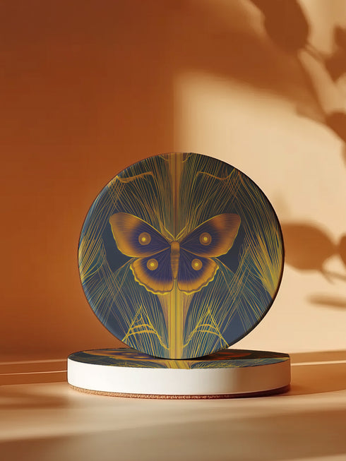 Round ceramic coaster featuring golden Luna moth illustration on dark green background with rose gold linear patterns. Cork-backed, 4-inch diameter. Perfect for vintage nature and gothic decor enthusiasts.